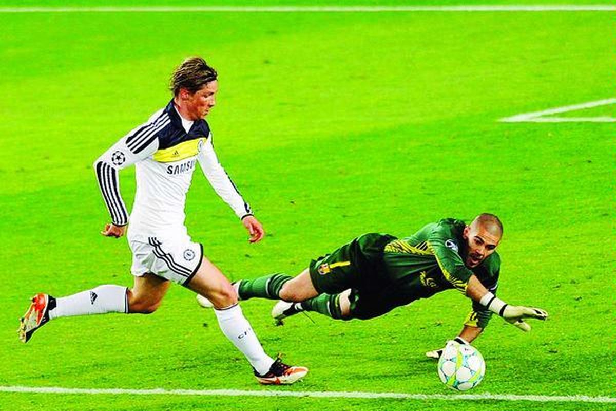 Pemain depan Chelsea asal Spanyol, Fernando Torres (kiri),  melewati penjaga gawang Barcelona,  Victor Valdes, dan menyarangkan gol kedua Chelsea ke gawang Valdes pada putaran kedua semifinal Liga Champions di Stadion Nou Camp, Selasa (24/4).