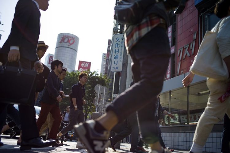 Para pejalan kaki melintasi kawasan ramai di Shibuya, Tokyo.