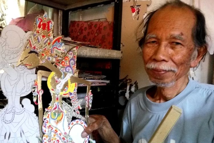 Tertib Suratmo saat menunjukan hasil karyanya wayang dari Kertas karton