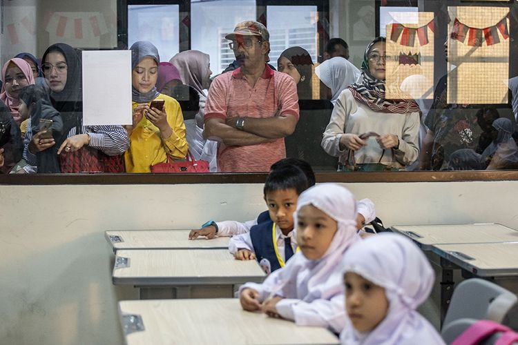 Sejumlah orang tua menyaksikan putra-putri mereka mengikuti proses belajar di hari pertama sekolah di SD Muhammadiyah 5 Jakarta, Kebayoran Baru, Jakarta Selatan, Senin (15/7/2019). Hari pertama masuk sekolah tahun ajaran 2019/2020 itu dilaksanakan secara serentak di Indonesia.