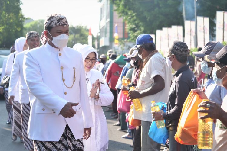 Wali Kota Madiun, Maidi bersama istri Yuni Setyawati memberikan bantuan sembako kepada tukang becak dan warga tidak mampu pada peringatan Hari Jadi Ke-104 Kota Madiun di Alun-Alun Kota Madiun, Senin (20/6/2022).