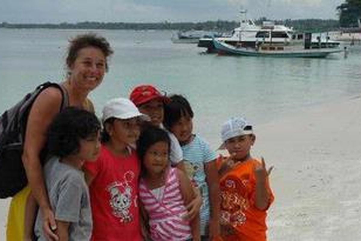 Yachter asal Australia disambut anak-anak Belitung yang sedang mempraktekkan kemampuan Bahasa Inggris aktifnya saat para yachter tiba di bibir Pantai Tanjung Kelayang, Belitung, tempat berlangsungnya Sail Indonesia 2010, Minggu (10/10/2010). Anak-anak tersebut mengajak sang yachter berfoto bersama.
