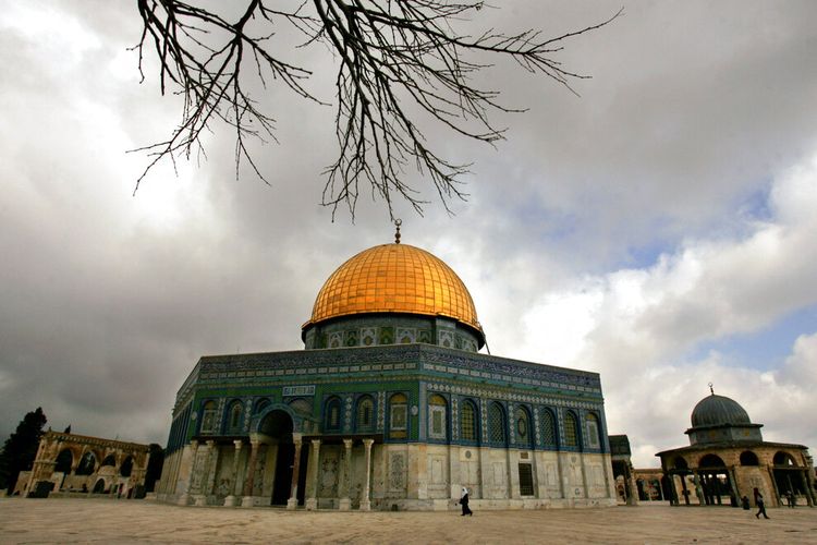 Jamaah Muslim Palestina berjalan di sebelah Masjid Kubah Emas Batu, di dalam kompleks Masjid Al Aqsa di kota tua Yerusalem, Senin, 2 April 2007. Baru-baru ini Australia batal akui Yerusalem sebagai ibu kota Israel.