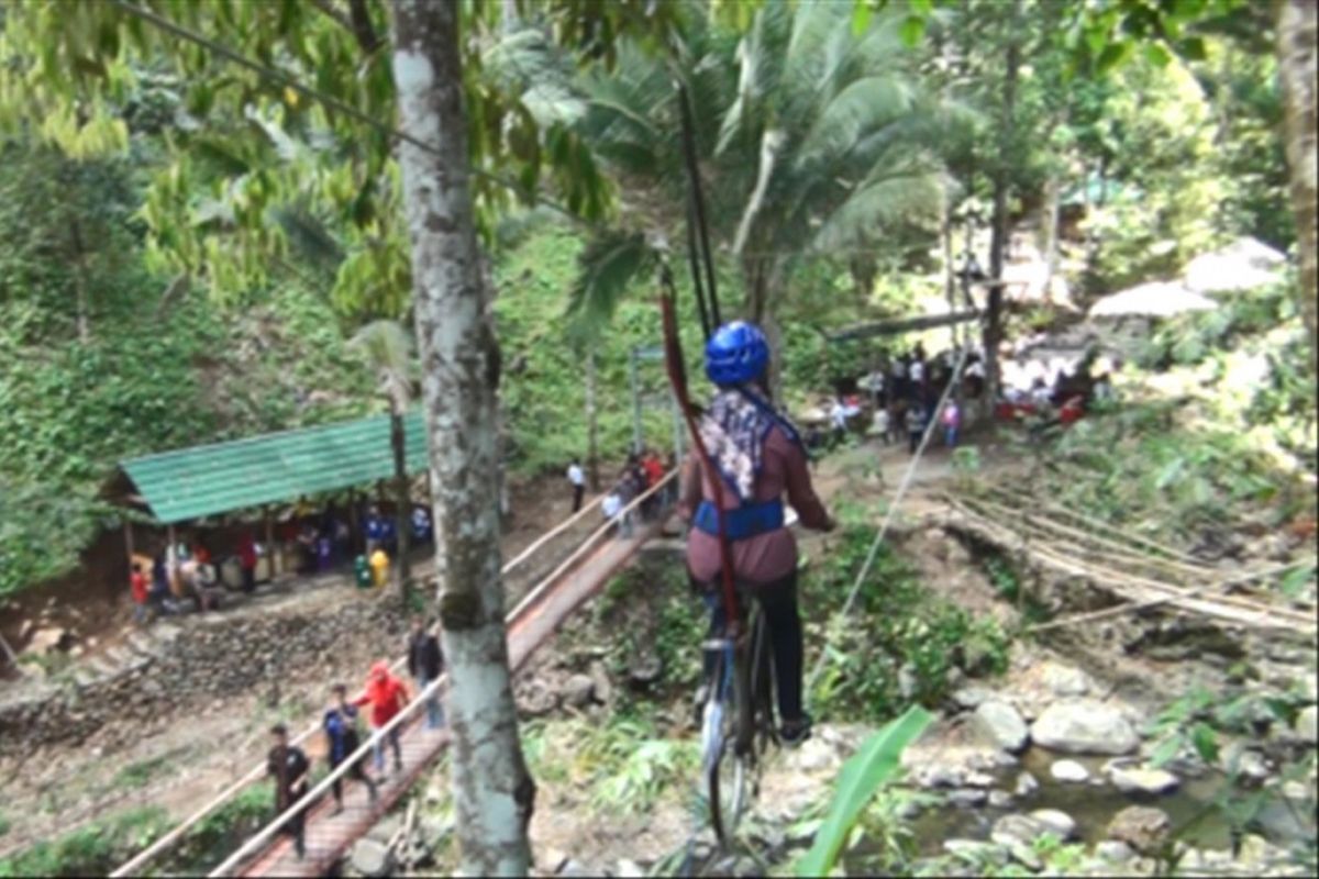 Wisatawan tengah bersepeda udara di kawasan wisata alam Banyu Nget Trenggalek