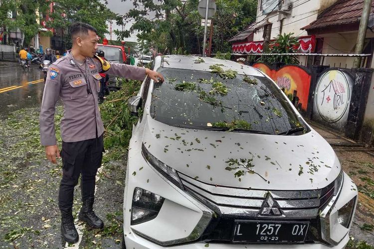Sebuah mobil Expander yang sedang parkir di Jalan Diponegoro Kelurahan Ahusen, kecamatan Sirimau, kota Ambon tertimpa pohon tumbang, Selasa (23/8/2022)