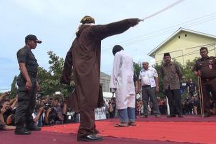 Tiga orang elaku judi sabung ayam di Banda Aceh menjalani hukuman cambuk, jumat (6/11/2015). Ini hukuman cambukpertama setelah disahkannya pelaksanaan qanun hukum jinayah sejak tanggal 23 Oktober 2015 lalu. *****K12-11