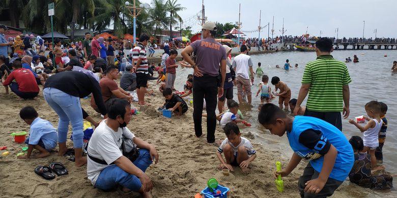 Keramaian wisatawan di Pantai Indah, Ancol, pada hari kedua libur Idul Fitri, Selasa (3/5/2022).