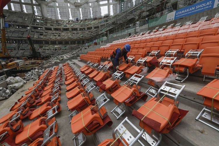 Pekerja memasang kursi penonton Jakarta International Stadium (JIS) di Tanjung Priok, Jakarta, Selasa (16/11/2021). Pembangunan stadion berkapasitas 82.000 penonton yang ditargetkan selesai pada akhir 2021 itu  berdasarkan data per 15 November 2021 telah mencapai 83,22 persen.