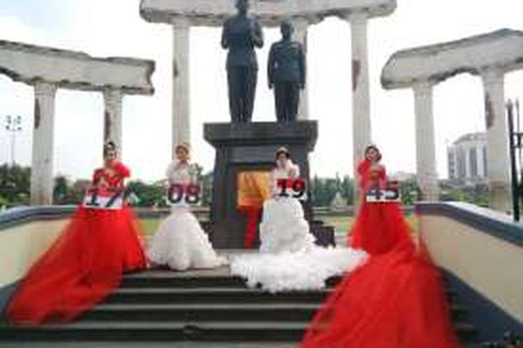 Empat model mengenakan kebaya merah-putih dan simbol tanggal kemerdekaan RI di Monumen Tugu Pahlawan, Surabaya, Jawa Timur, Senin (1/8/2016).