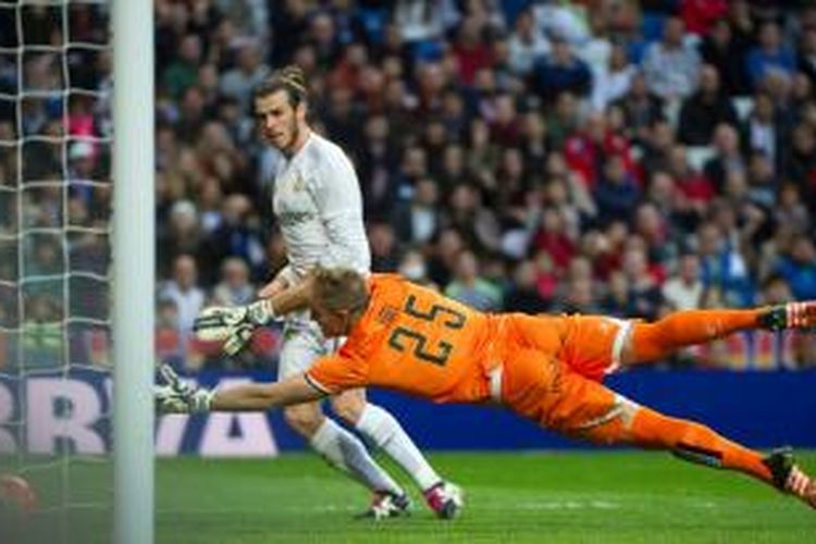 Gareth Bale menaklukkan Yoel pada pertandingan antara Real Madrid dan Rayo Vallecano di Stadion Santiago Bernabeu, Minggu (20/12/2015). Bale menyumbang empat dari sembilan gol Los Blancos dalam partai ini.