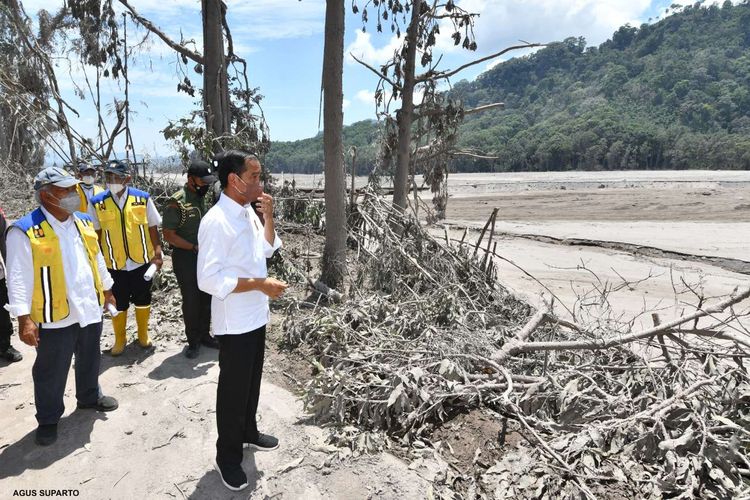 Indonesian President Joko Widodo (right) visits the collapsed Gladak Perak bridge in Candipuro sub-district, Lumajang regency in East Java on Tuesday, December 7, 2021 after Mount Semeru erupted on Saturday, December 4, 2021. The President pledged to rebuild the affected areas. 