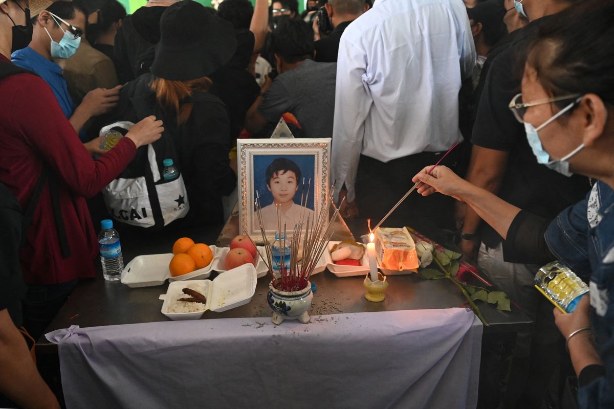 A photo of Khant Nyar Hein is surrounded by mourners in a Yangon graveyard on March 16, 2021, after the first-year medical student was shot dead during a demonstration against military rule. 