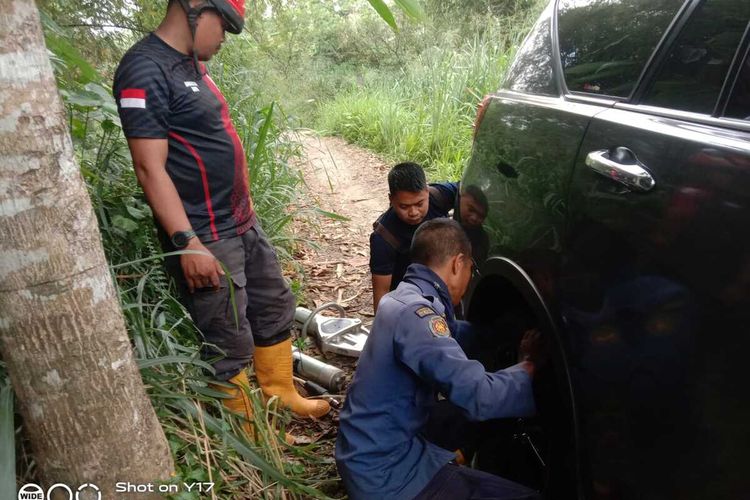 Petugas Damkar sedang mengevakuasi mobil Toyota Inova yang terperosok setelah mengikuti Google Maps di Tajurhalang, Kabupaten Bogor, Jawa Barat, Minggu (9/4/2023).