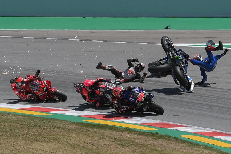 Pebalap Honda LCR Takaaki Nakagami (tengah) terjatuh sehingga berdampak pada jatuhnya pebalap Suzuki Alex Rins (kanan) dan pebalap Ducati Francesco Bagnaia (kiri) pada MotoGP Catalunya di Circuit de Catalunya pada 5 Juni 2022 di Montmelo di pinggiran Barcelona.