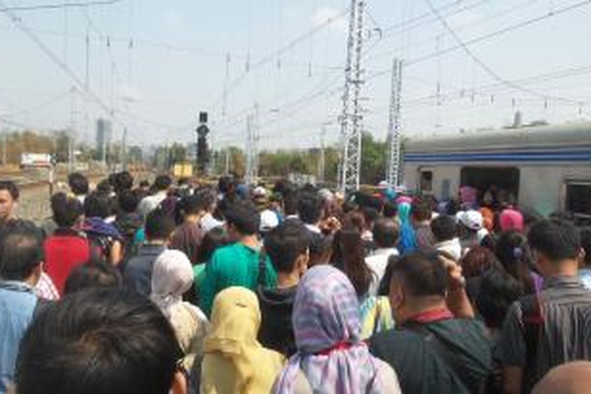 Para penumpang rangkaian KRL commuter line relasi Bogor-Tanah Abang-Jatinegara saat diminta untuk berpindah ke rangkaian KRL, di Stasiun Manggarai, Rabu (30/9/2015). Penumpang diminta untuk berpindah kereta karena adanya gangguan wesel di jalur lima Stasiun Manggarai.