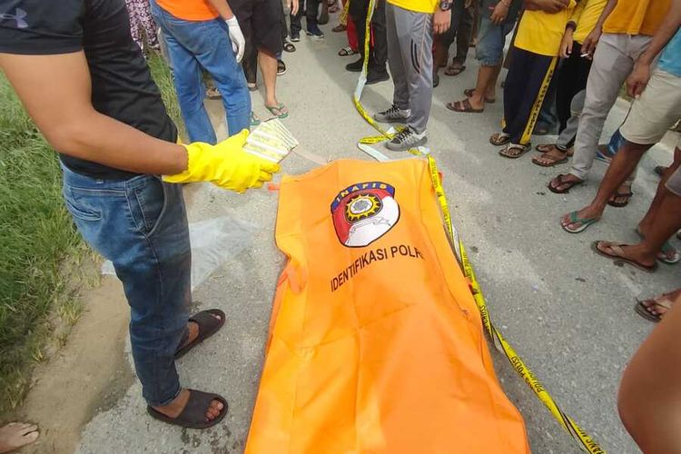 Petugas Polres Pelalawan saat mengevakuasi mayat pria yang ditemukan dalam parit di Jalan Pemda, Kecamatan Pangkalan Kerinci, Kabupaten Pelalawan, Riau, Sabtu (5/11/2022).