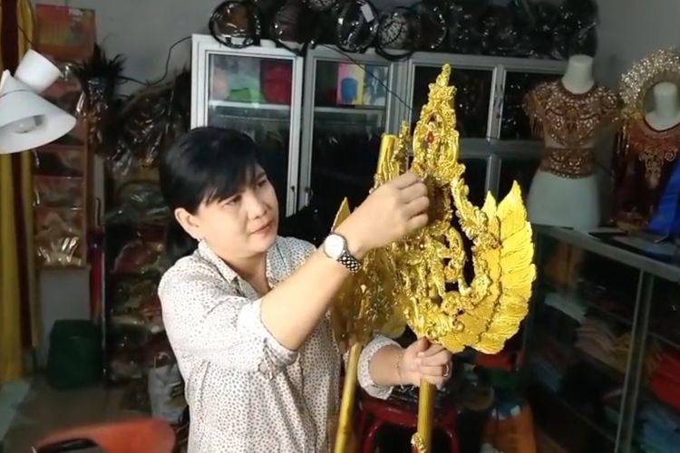 Pemilik jasa sewa baju karnaval Yuniar menunjukkan salah satu aksesoris baju karnaval yang disewakan untuk keperluan pawai budaya dan pawal hari kemerdekaan RI Ke-80.