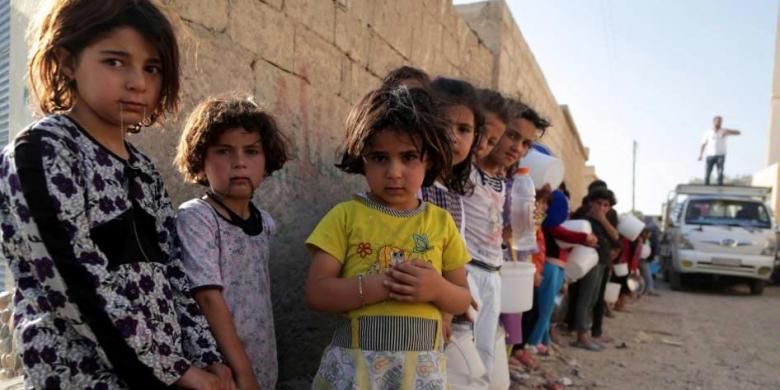 Anak Suriah mengantre makanan di utara Kota Raqqa, selama bulan suci Ramadhan, 14 Juli 2013. Kepala Koalisi Nasional Suriah Ahmad al-Assi telah mendukung seruan untuk gencatan senjata selama bulan suci Ramadhan dari Sekjen PBB Ban Ki-Moon.