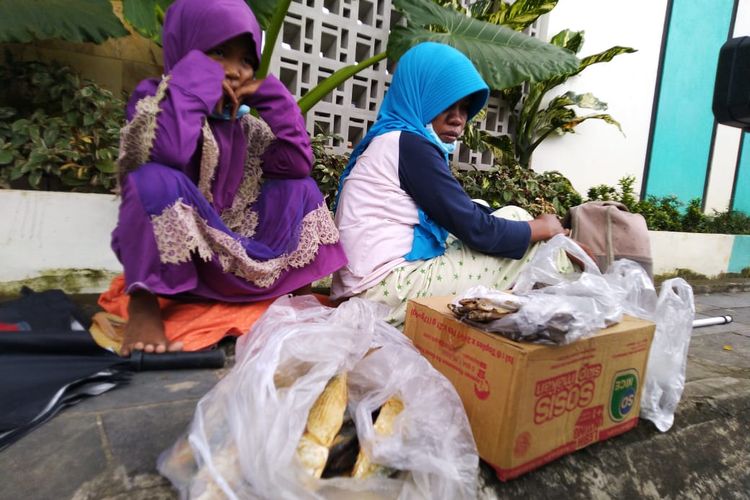 Misdah (37) bersama anaknya Maulida (5) saat jualan ikan asin di trotoar Jalan Bhayangkara, Taman Samarendah, Kota Samarinda, Kaltim, Rabu (20/5/2020). 