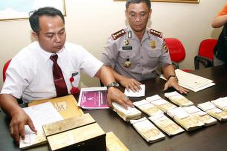 Polisi menunjukkan barang bukti uang palsu dollar Singapura yang ditangkap di Manado.