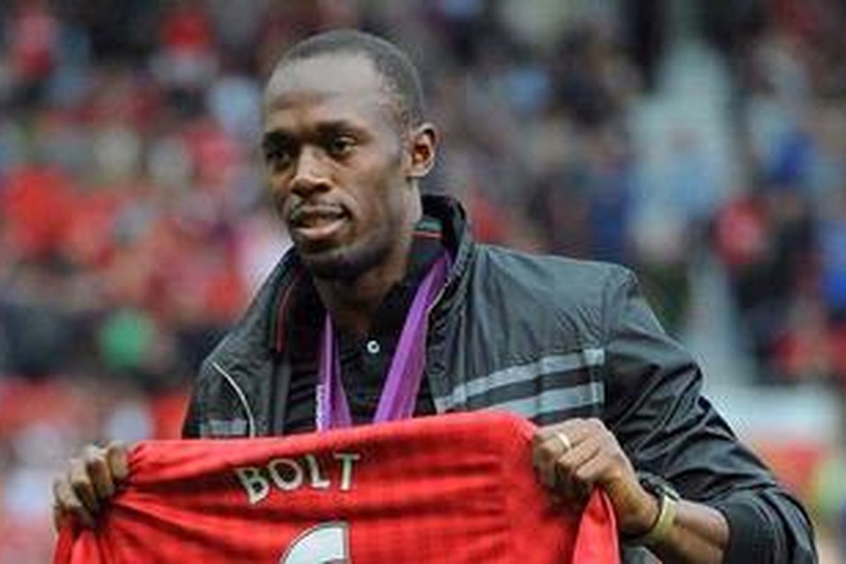 Pendukung Manchester United sekaligus sprinter kondang dari Jamaika, Usain Bolt, hadir di Old Trafford, Sabtu (25/8/2012), dan memamerkan kostum replika MU yang menunjukkan rekor lari 100 meter yang diukirnya jelang pertandingan Premier League melawan Fulham.