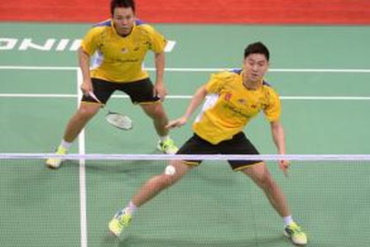 Pebulu tangkis ganda Malaysia, Tan Boon Heong (kanan)/Hoon Thien How, mengembalikan kok ke arah ganda Indonesia, Mohammad Ahsan/Hendra Setiawan, pada semifinal Piala Thomas di Siri Fort Indoor Stadium, di New Delhi, India, Jumat (23/5/2014).