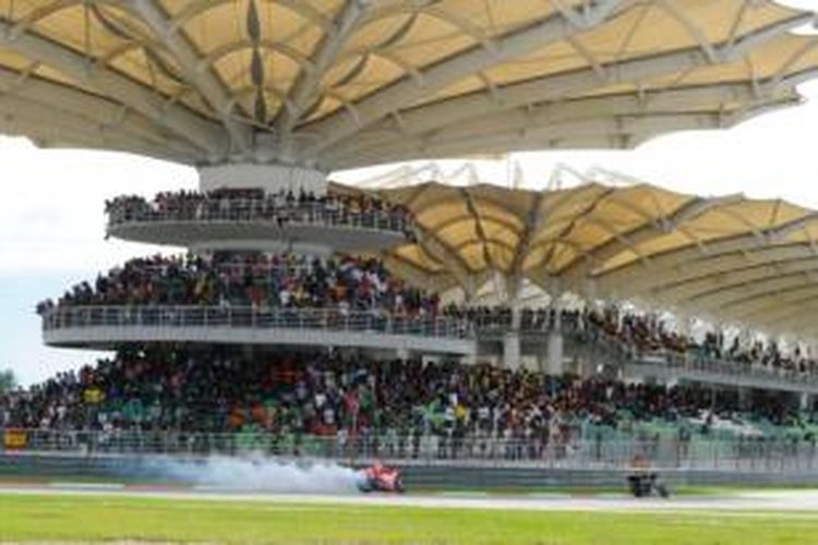 Pebalap Ducati asal Amerika Serikat, Nicky Hayden (belakang) memacu motornya yang mengeluarkan asap di Sirkuit Sepang, pada GP Malaysia, Minggu (13/10/2013).