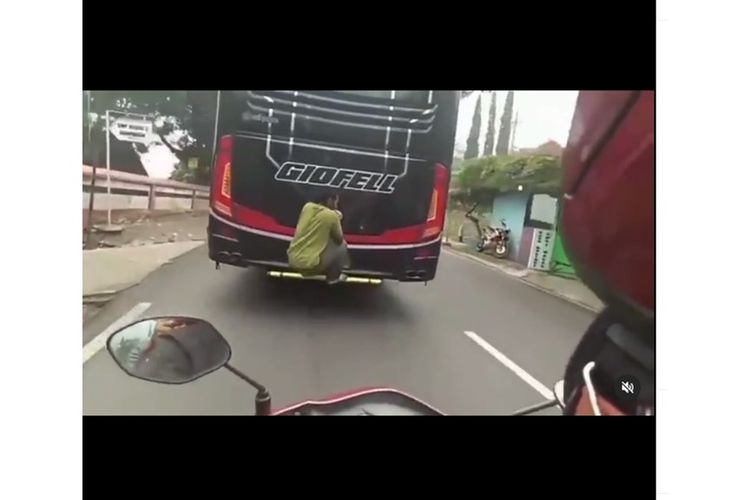 Viral video pria bergelantungan di bagian belakang bus
