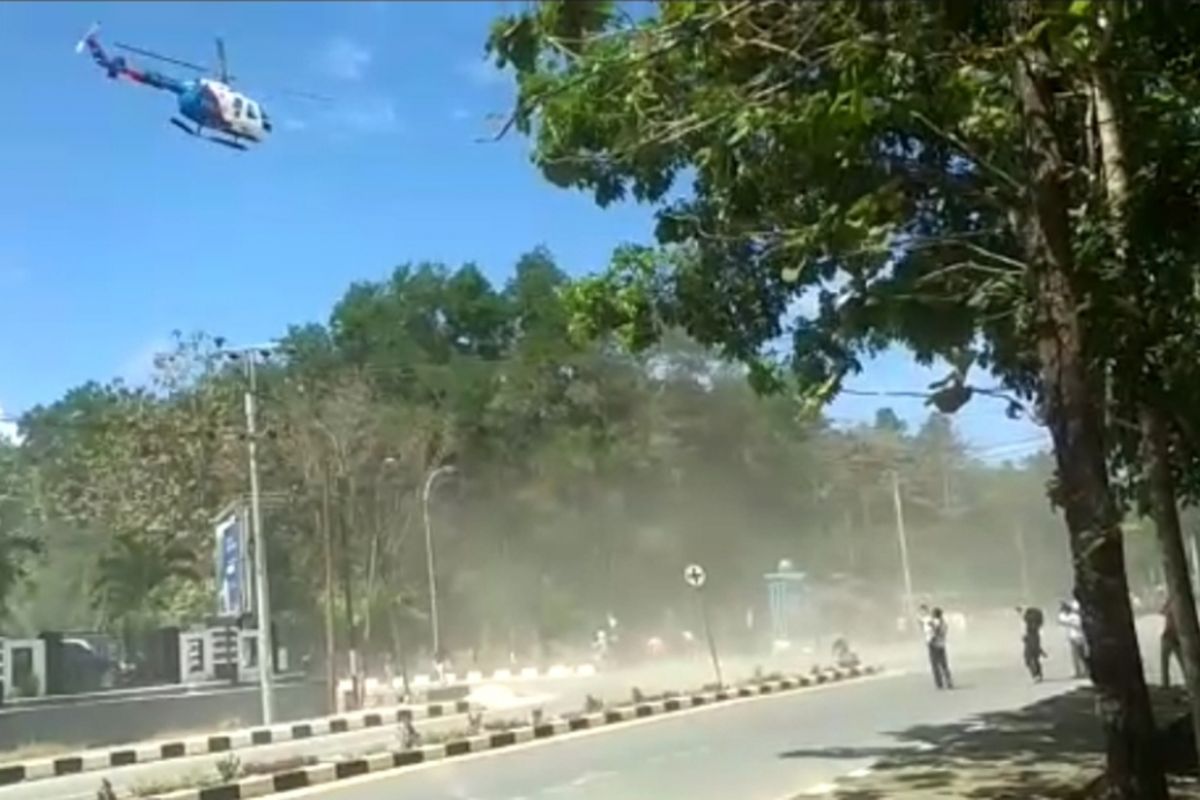 An Indonesian National Police helicopter disperses protesters in Kendari, Central Sulawesi on 26 September