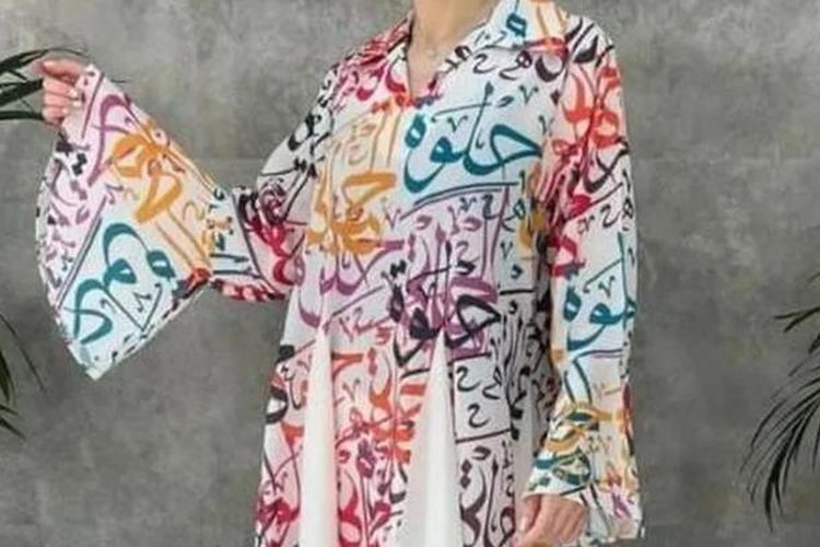 Gaun itu memiliki tulisan halwa yang dicetak dengan huruf Arab di atasnya. Halwa berarti manis dalam bahasa Arab.