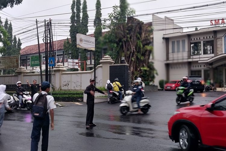 Para siswa SMAN 2 Tasikmalaya, Jawa Barat, terlihat terburu-buru masuk sekolah karena masuk lebih awal pada pukul 06.30 WIB di hari pertama masuk sekolah pada Senin (14/7/2025).