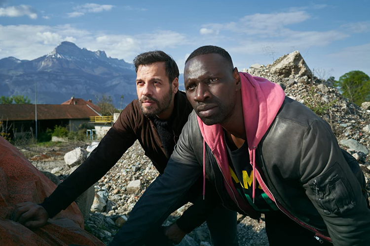 Ousmane Diakité (Omar Sy) dan François Monge (Laurent Lafitte) dalam film The Takedown