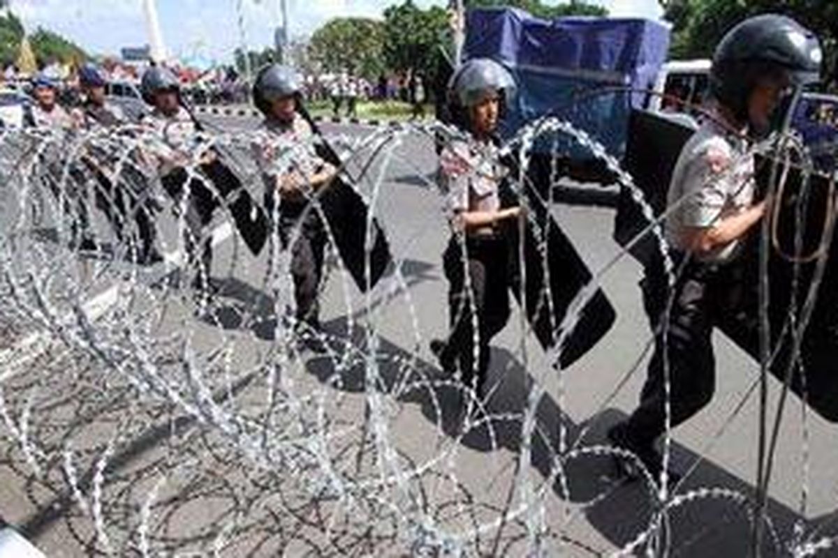 Aparat kepolisian mengamankan ribuan buruh yang turun ke jalan berunjuk rasa di depan Istana Negara, Jakarta, Rabu (21/3/2012), menolak rencana pemerintah menaikkan harga BBM. Pemerintah berencana menaikkan harga BBM pada 1 April 2012 ini dengan alasan akan meringankan beban APBN, dan menyalurkan alokasi subsidi BBM ke sektor lain. 