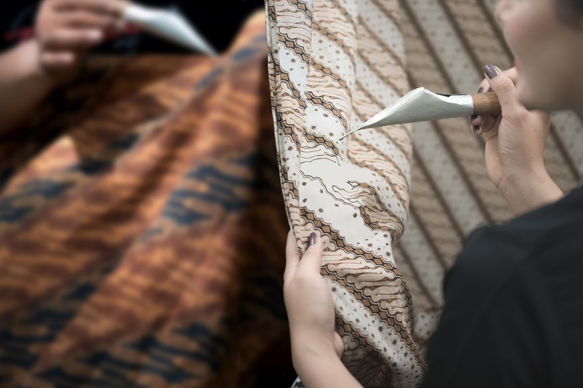Ilustrasi belajar membatik menggunakan canting dan malam. Batik warisan budaya dunia asli Indonesia.