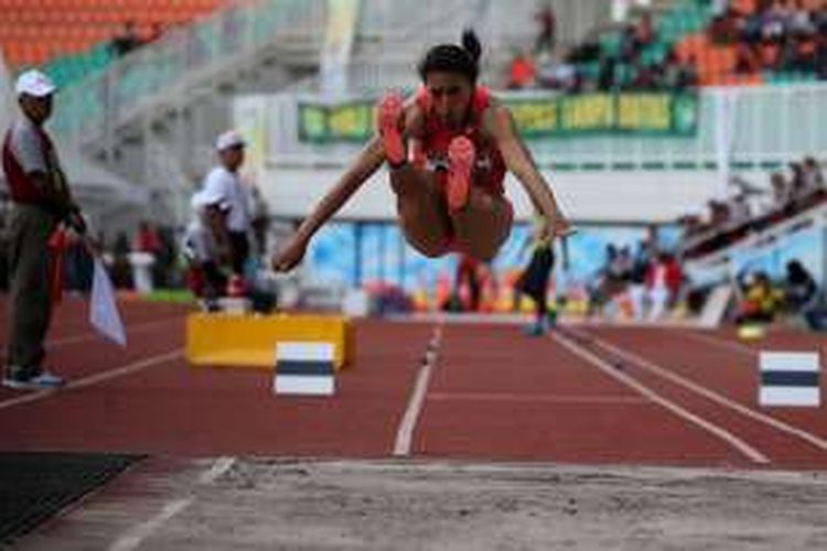 Atlet putri asal Bali, Maria Natalia Londa bertanding saat final  lompat jangkit putri PON XIX di Stadion Pakansari, Cibinong, Jawa Barat, Minggu (25/9/2016).  Ia meraih emas dengan hasil lompatan 13.52 meter.