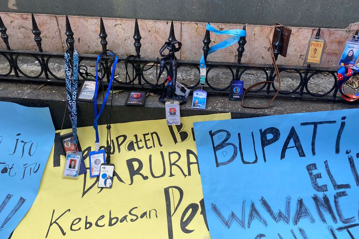 Sejumlah wartawan menggantungkan kartu pers di pagar rumah dinas bupati Blitar, Jumat (25/8/2023).