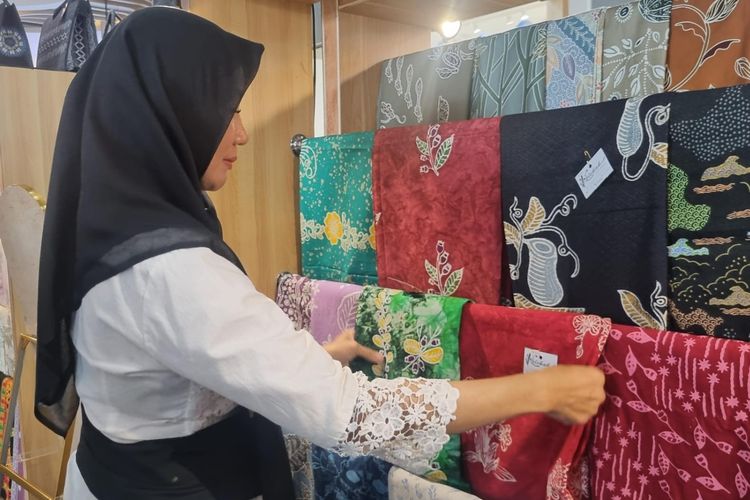 Pemilik Kelekak Batik Belitong, Diana, saat menunjukkan kain batik produksinya yang dipamerkan pada acara Festival Ekonomi Syariah (FESyar) Sumatera 2025 di Lampung City Mall, Bandar Lampung, Selasa (25/6/2025).