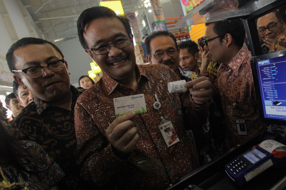 Gubernur DKI Jakarta (tengah) menunjukan kartu debit yang dapat di gunakan sebagai alat transaksi di JakGrosir Pasar Induk Kramatjati. Jakarta, Jumat (8/9/2017). Gubernur DKI Jakarta Djarot meresmikan JakGrosir di Pasar Induk Kramatjati dengan tujuan memotong mata rantai distribusi barang dan pangan di Jakarta, pasar milik PD Pasar Jaya ini difokuskan untuk membantu pedagang kelontong mendapat harga murah di bawah harga pasaran. ANTARA FOTO/Makna Zaezar/pd/17.