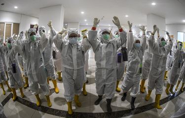 Sejumlah tenaga kesehatan meneriakan yel-yel sebelum melakukan pergantian jadwal perawatan pasien COVID-19 di Rumah Sakit Darurat (RSD) COVID-19, Wisma Atlet Kemayoran, Jakarta, Selasa (26/1/2021). Satuan Tugas Penanganan COVID-19 Pusat mengumumkan per Selasa (26/1) pukul 15.55 WIB, terdapat penambahan jumlah kasus terkonfirmasi positif COVID-19 sebanyak 13.094 orang sehingga total telah mencapai 1.012.350 kasus di Indonesia.  ANTARA FOTO/M Risyal Hidayat/wsj.