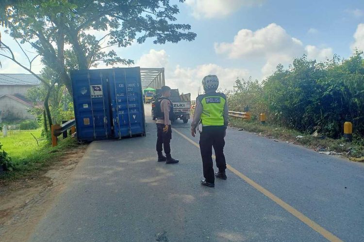 Boks kontainer tercecer saat menaiki Jembatan Kuala Ambawang di Jalan Trans Kalimantan, Kecamatan Sungai Ambawang, Kabupaten Kubu Raya, Kalimantan Barat (Kalbar) Kamis (18/5/23). Peristiwa tersebut diduga akibat kelalaian sopir yang tidak melakukan pengecekan sebelum mengangkut kontainer kosong.