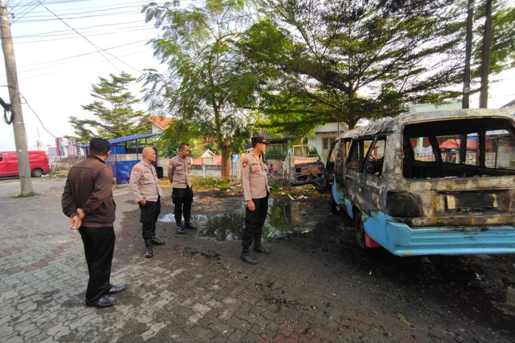 Anggota Polres Salatiga memeriksa kondisi angkutan kota yang terbakar di halaman parkir ruko Jalan Taman Pahlawan.