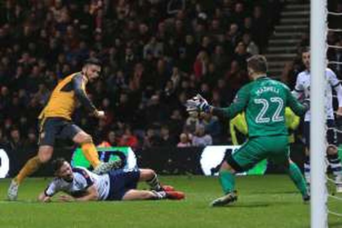 Olivier Giroud mencetak gol Arsenal ke gawang Preston pada partai babak ketiga Piala FA di Stadion Deepdale, Sabtu (7/1/2017).