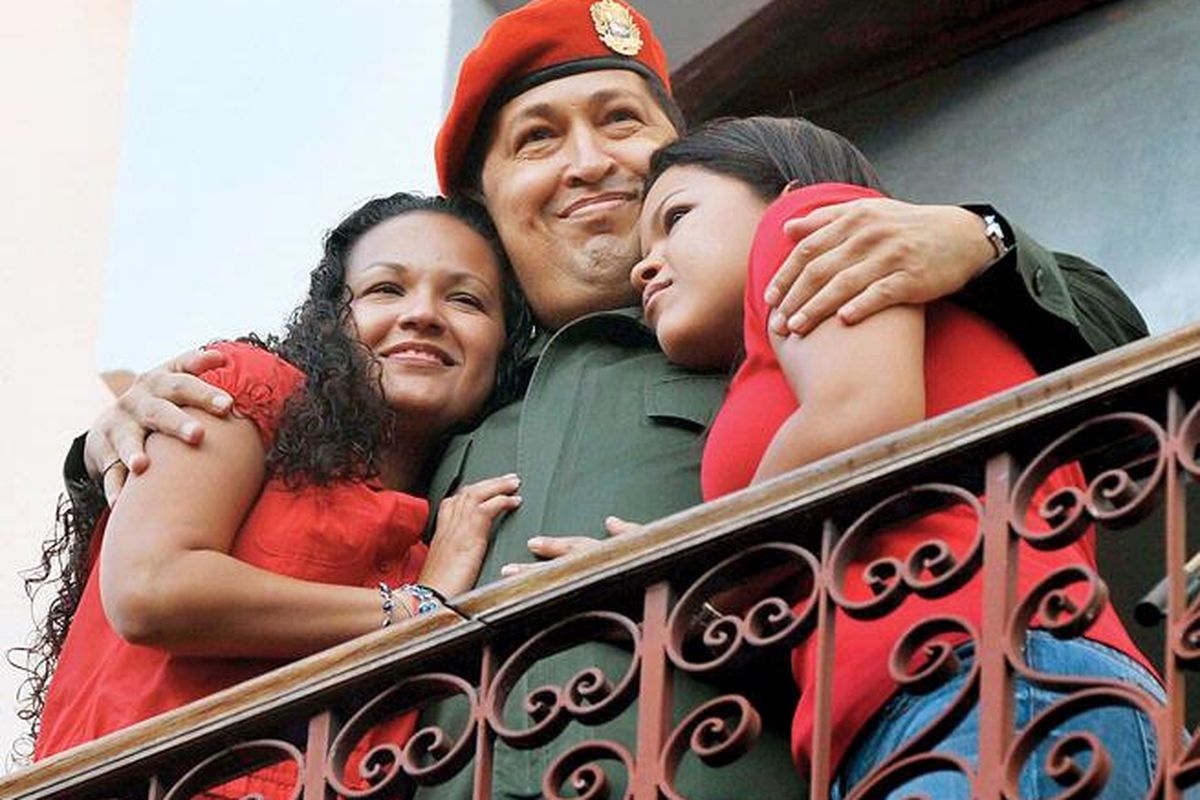 Presiden Venezuela  Hugo Chavez memeluk putrinya, Maria (kiri) dan Rosa, di Istana Miraflores di Caracas, Venezuela,  Senin (4/7).  Chavez pulang ke Venezuela setelah menjalani perawatan selama tiga pekan di Kuba untuk pengangkatan tumor kanker.