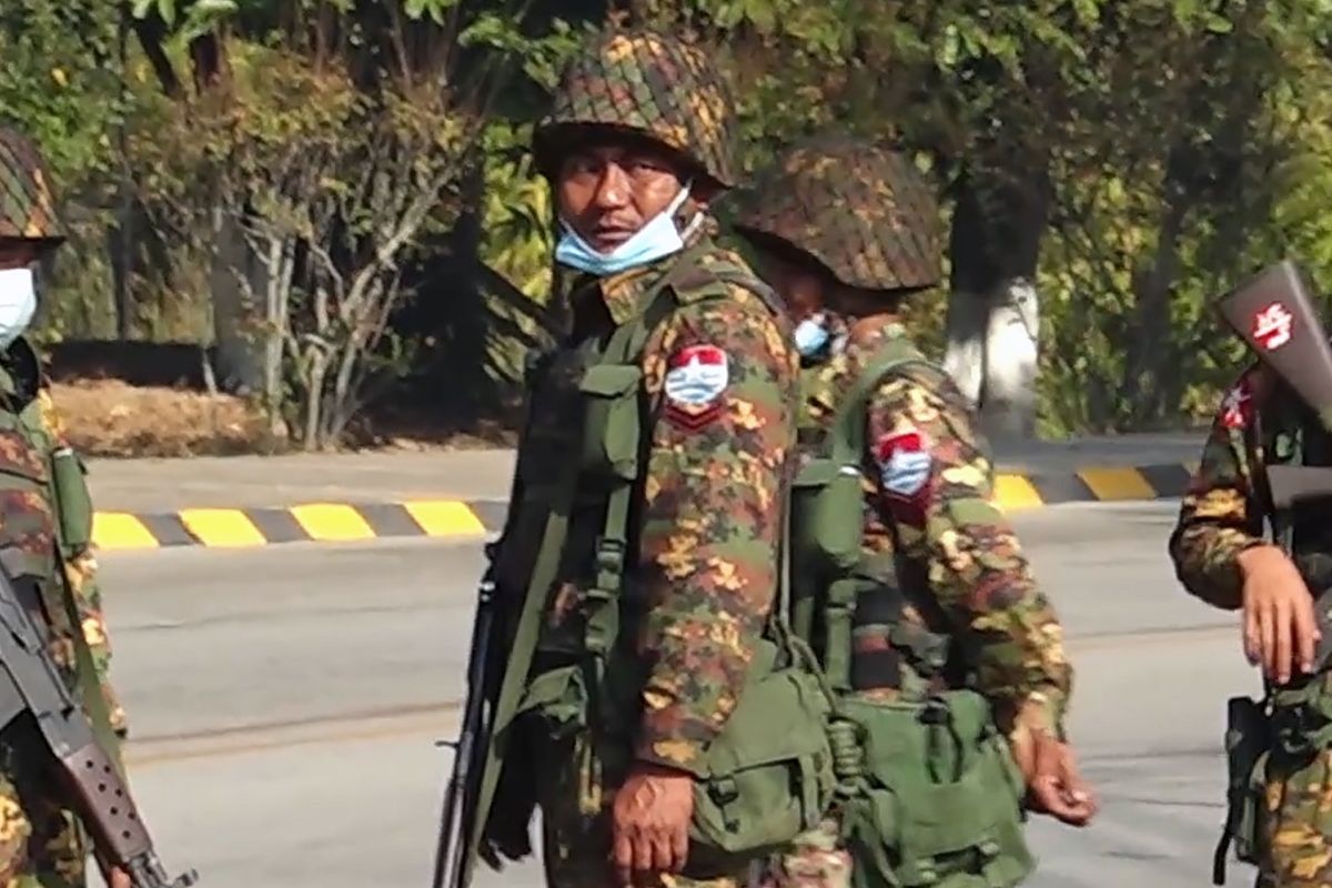 Soldiers stand guard on a street in Naypyidaw on February 1, 2021, after the military detained the country's de facto leader Aung San Suu Kyi and the country's president in a coup. (Photo by STR / AFP)