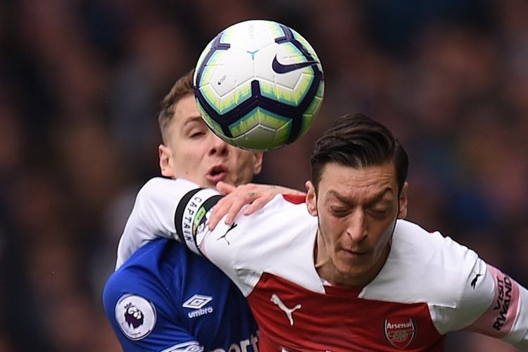 Mesut Oezil dijaga Lucas Digne pada pertandingan Everton vs Arsenal dalam lanjutan Liga Inggris di Stadion Goodison Park, 7 April 2019. 