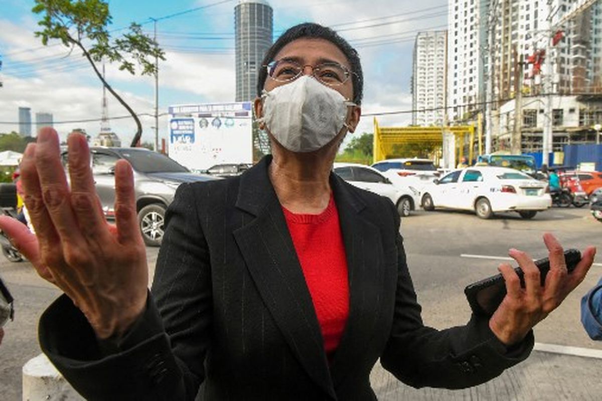 (FILES) This file photo taken on March 4, 2021 shows Philippine journalist Maria Ressa speaking to members of the media as she arrives at a court in Manila. Rappler, a Philippine news site co-founded by Nobel Peace Prize winner Maria Ressa, has been ordered to shut down, the company said on June 29, 2022, a day before President Rodrigo Duterte - its arch-nemesis - leaves office.