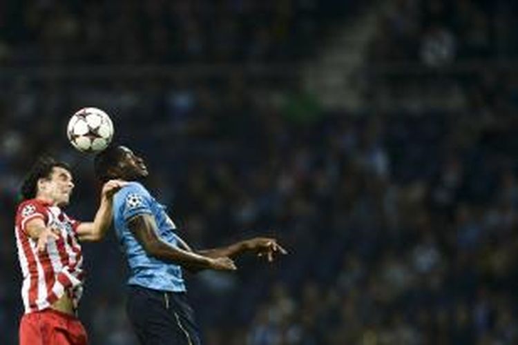 Gelandang Atletico Madrid asal Portugal, Tiago (kiri), berebut bola dengan pemain FC Porto asal Kolombia, Jackson Martinez, dalam matchday kedua Grup G Liga Champions di Dragao Stadium, Portugal, Selasa (1/10/2013). Atletico menang 2-1.