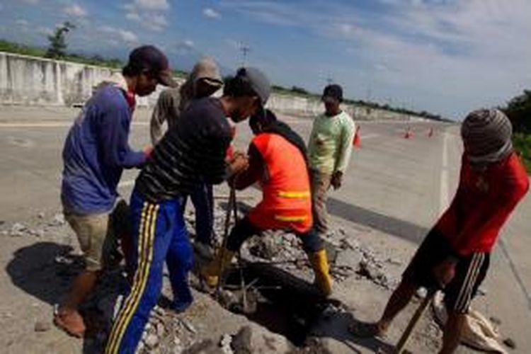 Para pekerja melakukan perbaikan Jalur Pantai Utara (Pantura) di sekitar Tol Palikanci, Cirebon, Jawa Barat, Minggu (28/7/2013). Rencananya proyek perbaikan ini akan rampung pada 10 hari sebelum Idul Fitri.