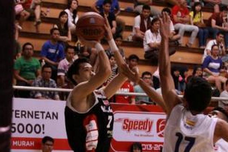 Pemain Dell Aspac Jakarta, Riko Hantono (kiri), melakukan tembakan tiga poin, pada laga melawan JNE BSC Bandung Utama, di DBL Arena Surabaya, Minggu (22/9/2013).