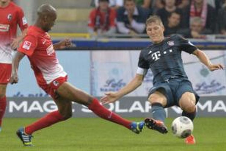 Gelandang Bayern Muenchen, Bastian Schweinsteiger (kanan), pada laga melawan Freiburg di Mage Solar Stadion, Selasa (27/8/2013). Pada laga itu, Schweinsteiger mengalami cedera engkel.